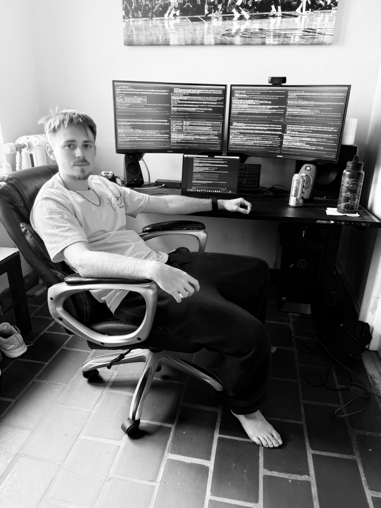 Joseph Stevenson at his desk, two monitors of agent sessions running